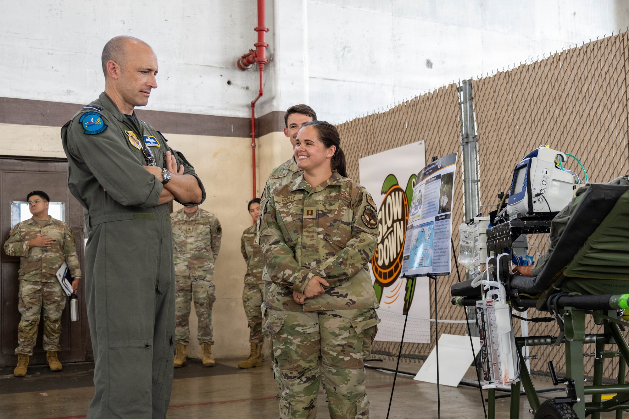 Royal Australian Air Force Air Vice-Marshal David Titheridge, Pacific Air Forces deputy commander, speaks to U.S. Air Force Capt. Amanda Harley, 15th Healthcare Operations Squadron Critical Care Air Transport Team registered nurse, at Joint Base Pearl Harbor-Hickam, May 19, 2026. Harley briefed on CCAT capabilities and the coordinated processes that enable advanced medical care during aeromedical evacuation operations. (U.S. Air Force photo by Senior Airman Lauren Torres)