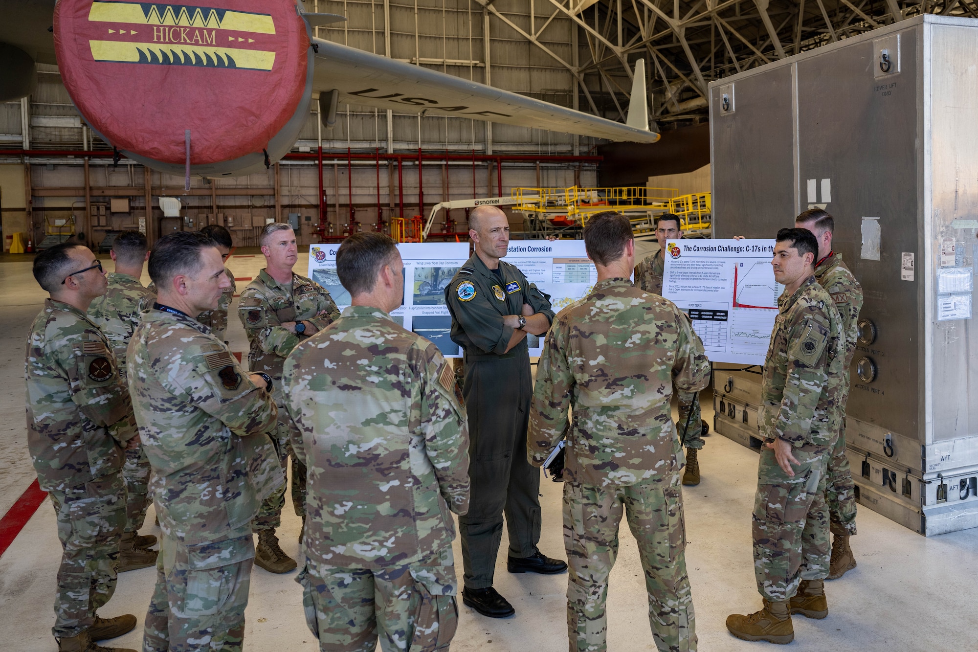 Royal Australian Air Force Air Vice-Marshal David Titheridge, Pacific Air Forces deputy commander, is briefed by Airmen from the 15th Maintenance Squadron at Joint Base Pearl Harbor-Hickam, May 19, 2026. The Airmen highlighted the value and importance of corrosion prevention for 15th Wing aircraft. (U.S. Air Force photo by Senior Airman Lauren Torres)