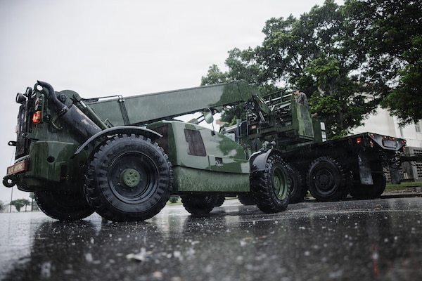 A U.S. Marine Corps military millennium vehicle assigned to III Marine Expeditionary Force Support Battalion carries an air conditioning unit during Kaiju Rain 26 at Camp Courtney, Okinawa, Japan, May 9, 2026.
