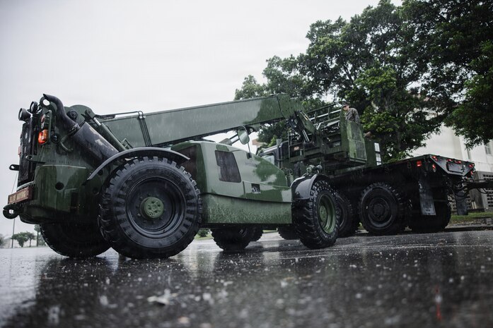 A U.S. Marine Corps military millennium vehicle assigned to III Marine Expeditionary Force Support Battalion carries an air conditioning unit during Kaiju Rain 26 at Camp Courtney, Okinawa, Japan, May 9, 2026.
