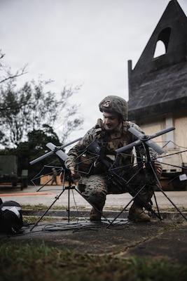 U.S. Marine Corps Cpl. Connor Boone, a native of Missouri and a transmissions systems operator with 7th Communication Battalion, III Marine Expeditionary Force Information Group, sets up portable multi-band tactical antenna systems during Kaiju Rain 26 at Camp Hansen, Okinawa, Japan, May 9, 2026.