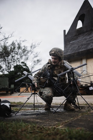 U.S. Marine Corps Cpl. Connor Boone, a native of Missouri and a transmissions systems operator with 7th Communication Battalion, III Marine Expeditionary Force Information Group, sets up portable multi-band tactical antenna systems during Kaiju Rain 26 at Camp Hansen, Okinawa, Japan, May 9, 2026.