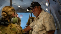 Civic leader and Airman chatting on aircraft