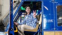 Civic leader poses for photo in aircraft cockpit