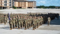Air Force trainees stand in formation during graduation