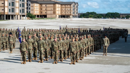 Air Force trainees stand in formation during graduation