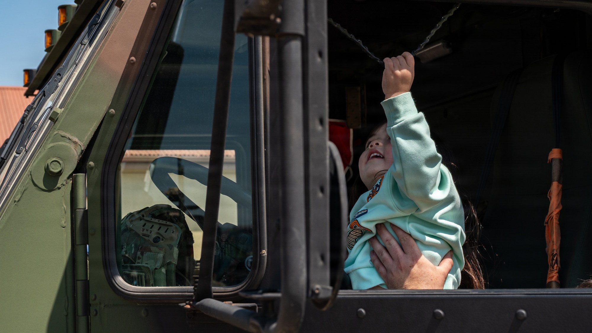 A child pulls a horn lanyard.