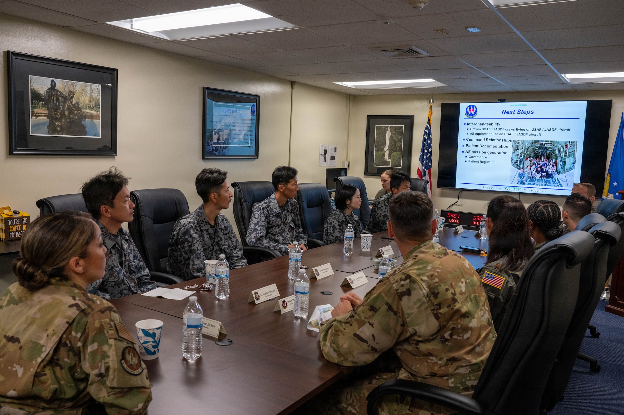 U.S. service members brief foreign service members on mission.