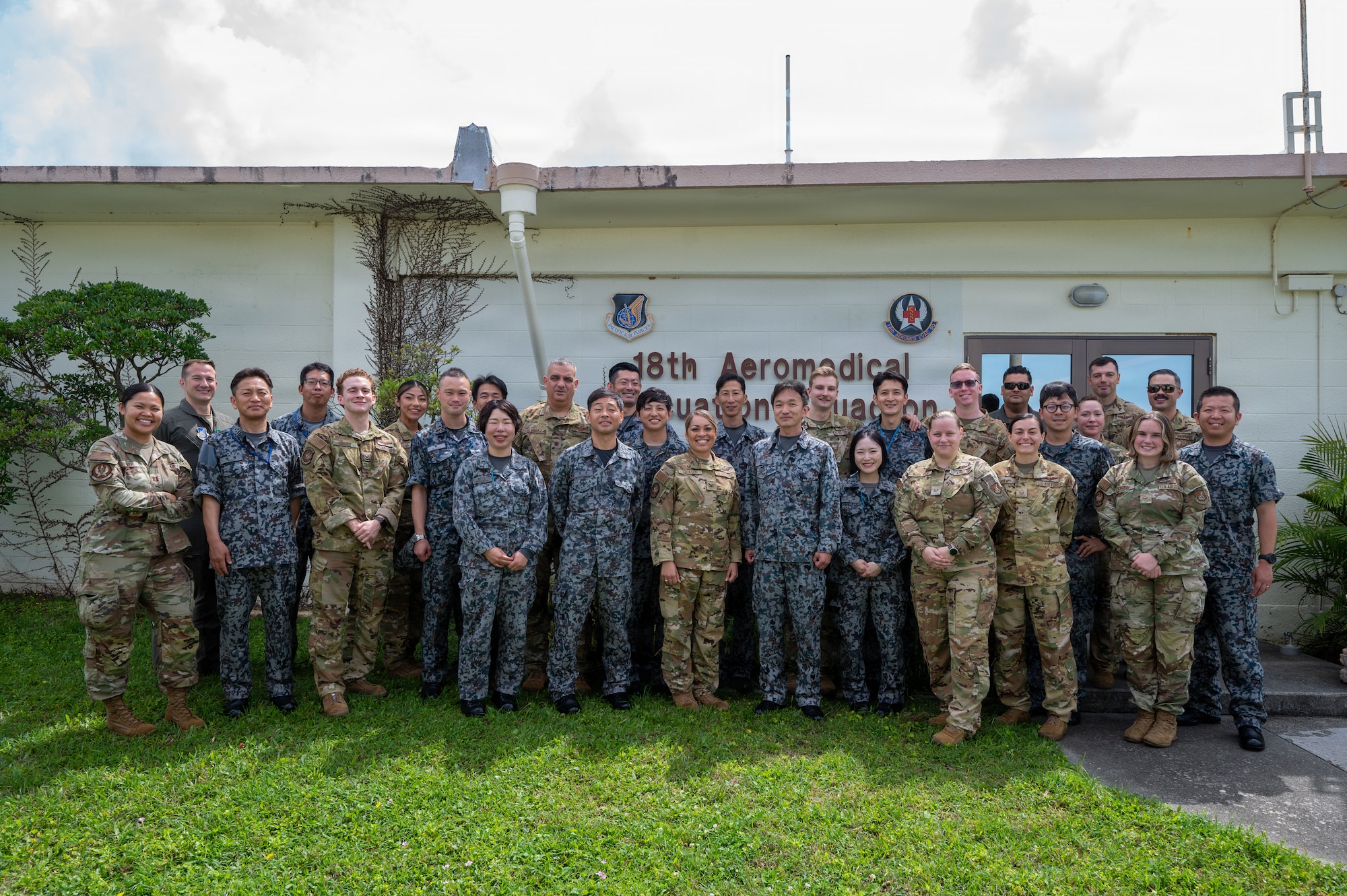 U.S. and Foreign service members pose for group photo.