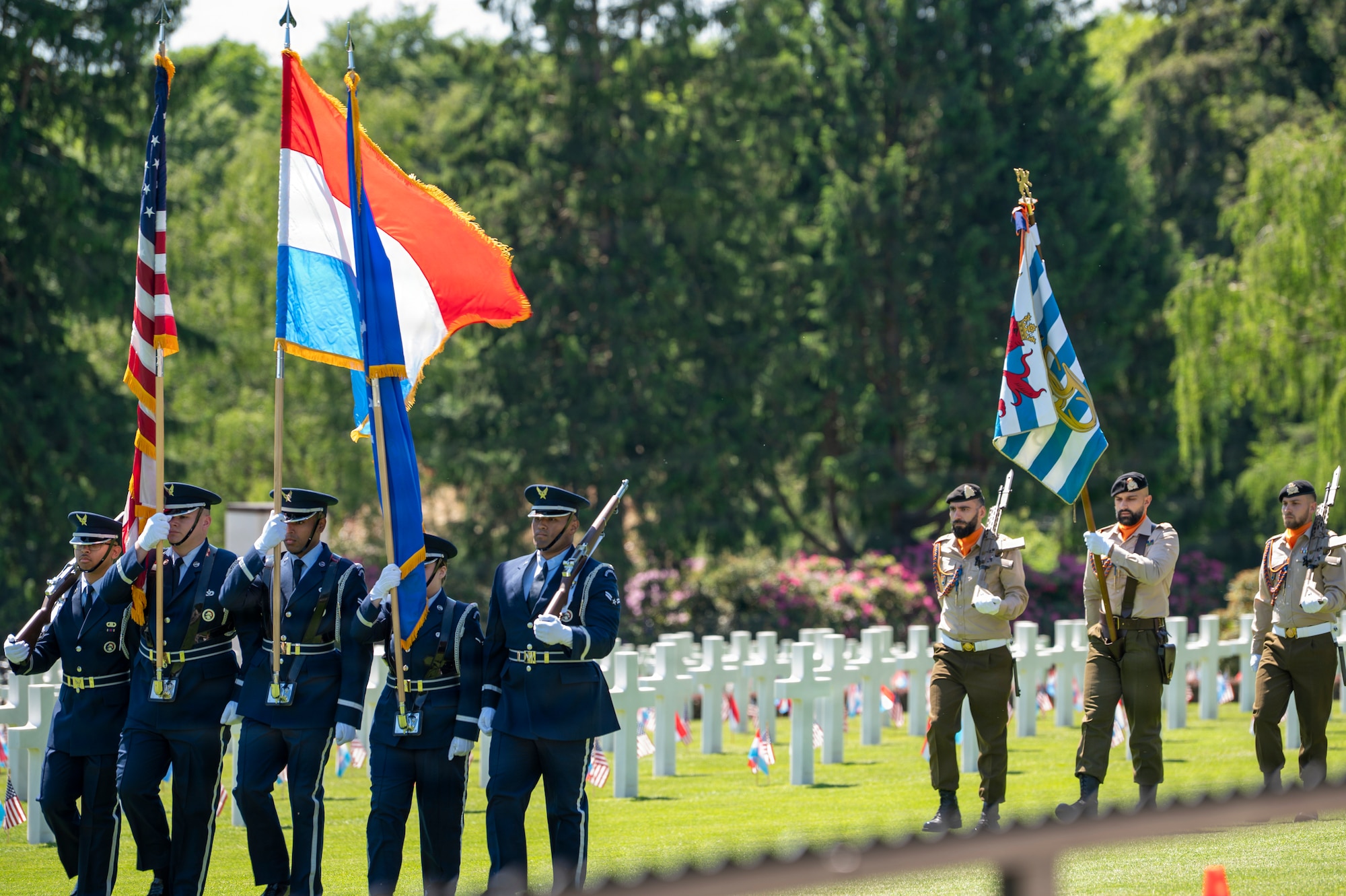 A photo of Ramstein Air Base Honor Guardsmen marching during a Memorial Day ceremony at Luxembourg American Cemetery.