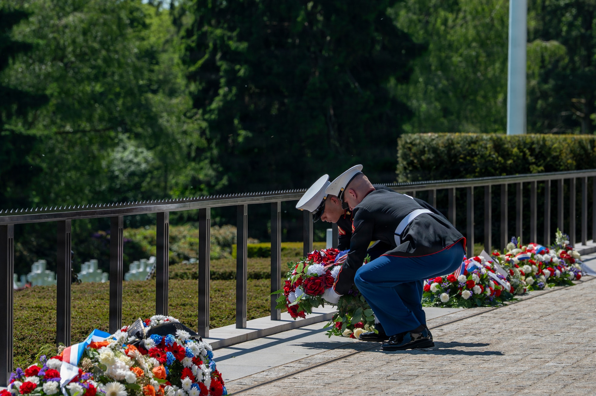 A photo of two Marines laying down a wreath during a Memorial Day ceremony at Luxembourg American Cemetery.