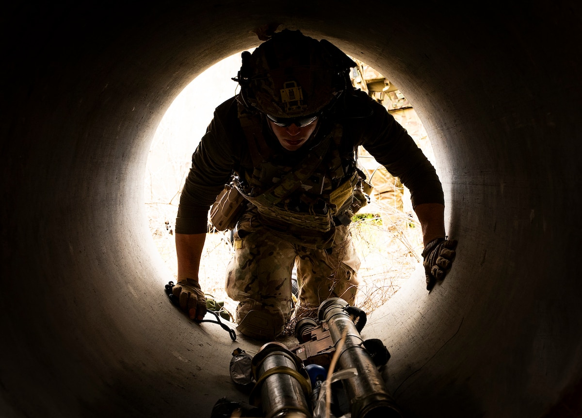 Staff Sgt. Richard Olivier Feliz, 92nd Civil Engineer Squadron, crawls through a culvert during an exercise at Eglin Air Force Base, Fla., May 6, 2026. The exercise was part of the 96th Test Wing-hosted Explosive Ordnance Disposal Warfighter event, a two-week training focused on current challenges and mission-relevant scenarios across the EOD career field. (U.S. Air Force photo by Samuel King Jr.)