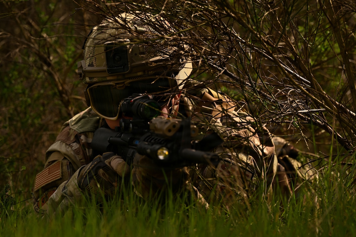 Tech. Sgt. Ethan Sweet, 194th Security Forces Squadron fire team leader, Washington Air National Guard, takes cover during a dismounted patrol at Joint Base Lewis-McChord, Wash., May 1, 2026. The training strengthened Airmen’s ability to move tactically, communicate effectively and respond decisively in realistic scenarios. (U.S. Air National Guard photo by Senior Airman Jordaan Kvale)