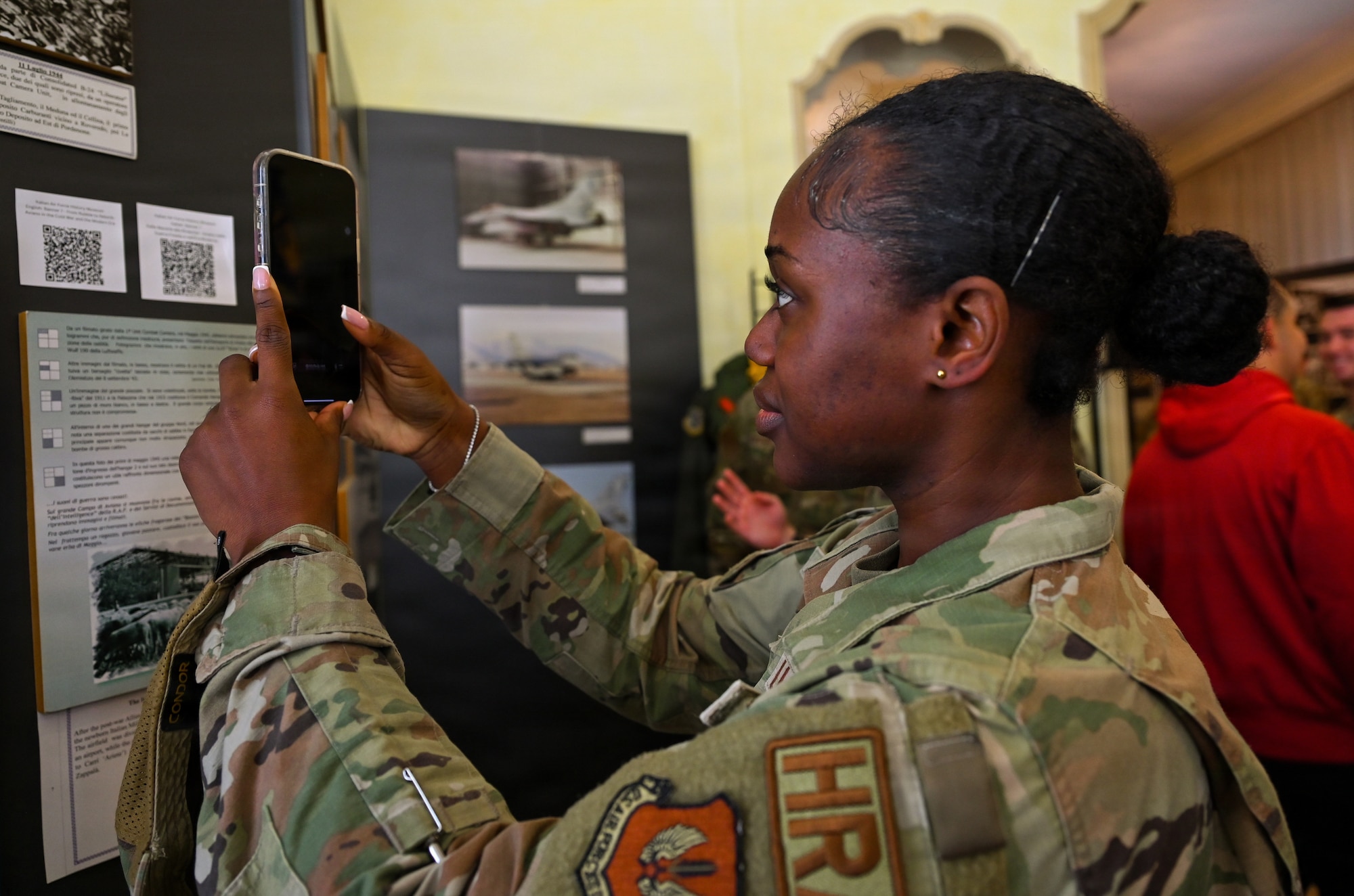 U.S. Air Force Senior Airman Delores Lotharp, 31 Civil Engineer Squadron human resources and administration commander support staff technician, uses a new QR code system at the Italian air force History Museum at Aviano Air Base, Italy, May 12, 2026.