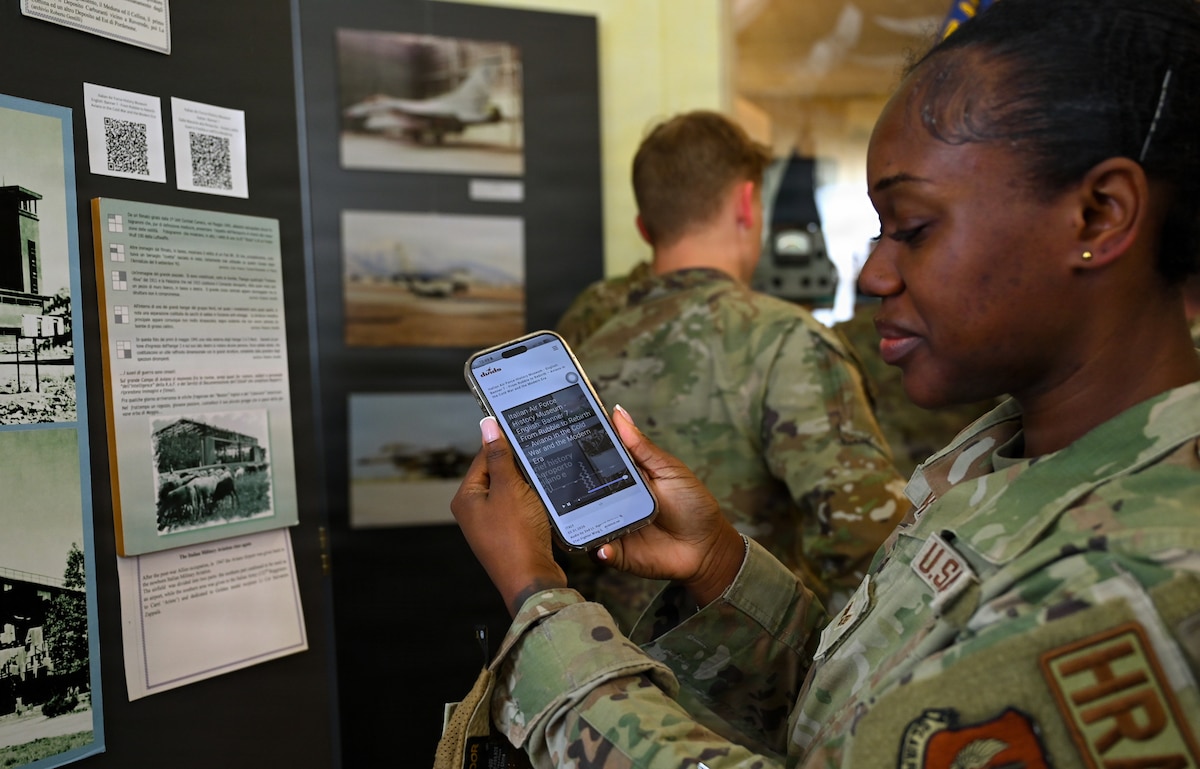 U.S. Air Force Senior Airman Delores Lotharp, 31 Civil Engineer Squadron human resources and administration commander support staff technician, loads the English translation of Italian history at the Italian air force History Museum at Aviano Air Base, Italy, May 12, 2026.