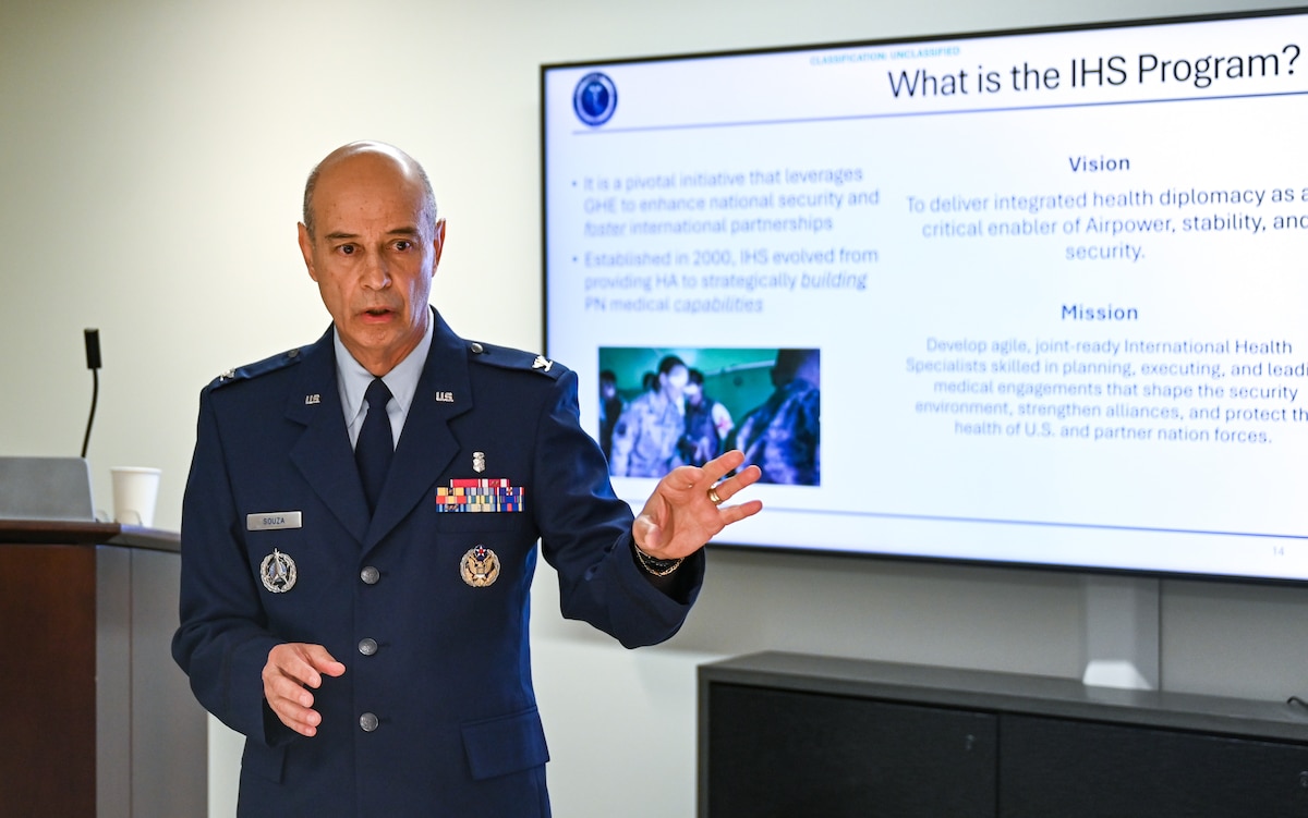Image of an Airman speaking to a crowd.