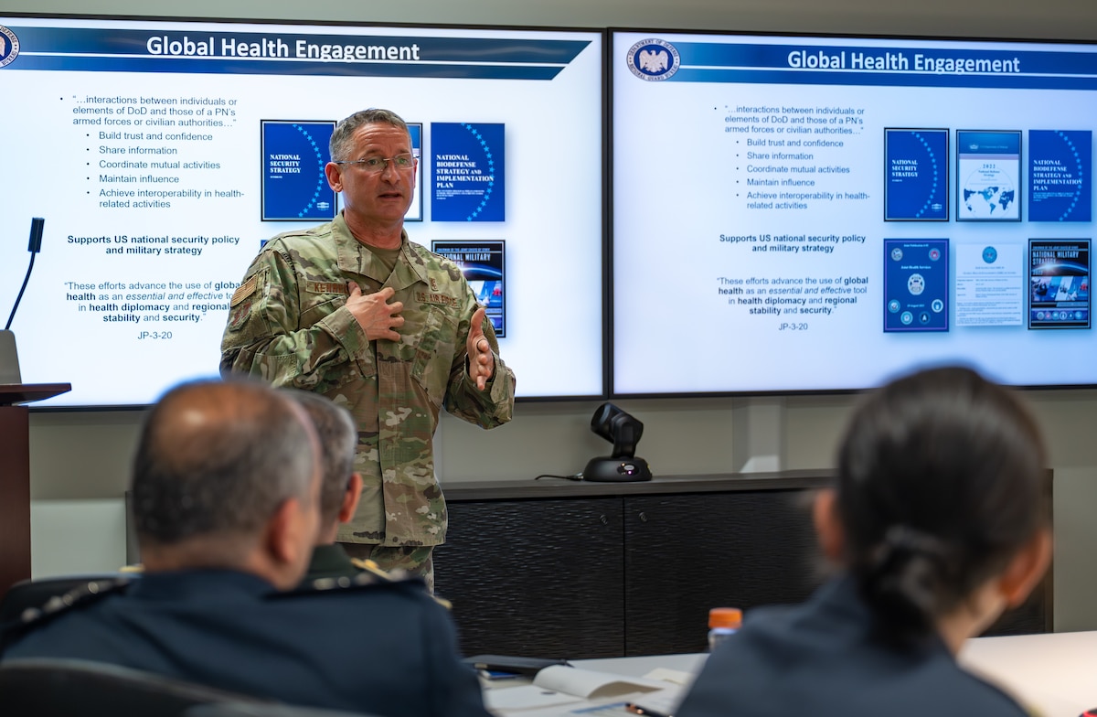 Image of an Airman talking to a crowd.