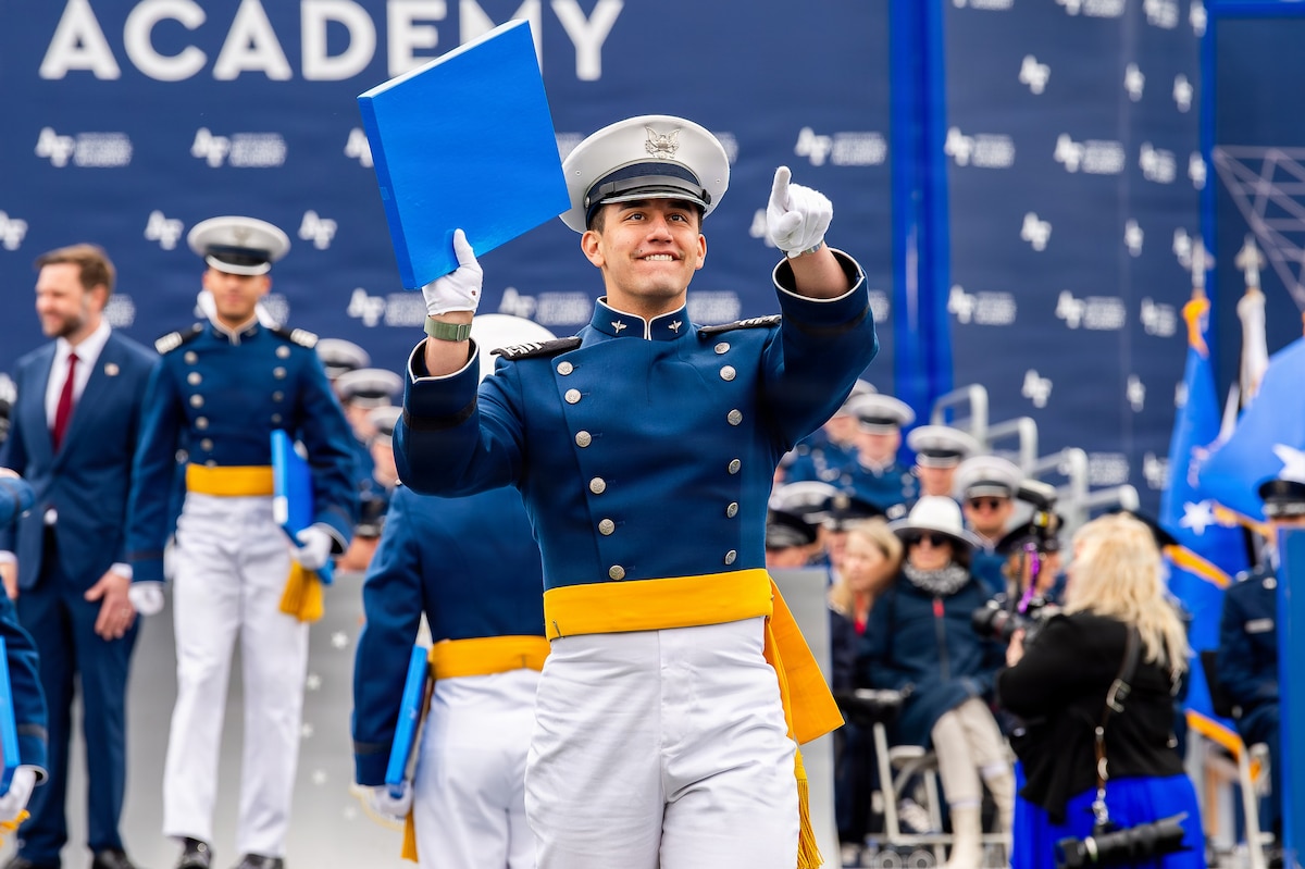 A cadet hoists their diploma during the U.S. Air Force Academy Class of 2026 graduation ceremony at Falcon Stadium in Colorado Springs, Colo., May 28, 2026. A total of 931 cadets received commissions as second lieutenants in the U.S. Air Force and U.S. Space Force.  (U.S. Air Force photo/Adalyn Greene)