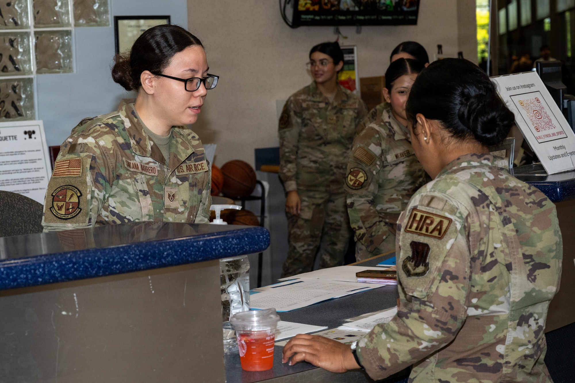 An airman talks to another woman.