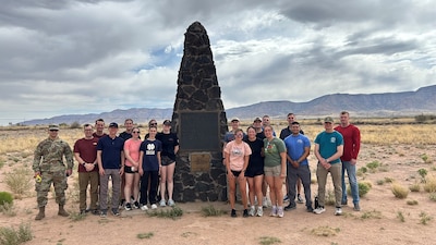 Participants gather at the Trinity Site memorial at White Sands .
