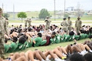 Student-athletes from high schools around Central Texas complete sit-ups while arms are interlocked with the people next to them during the Basic Training Challenge at the U.S. Army Experience March 25, 2026, at Fort Hood, Texas.