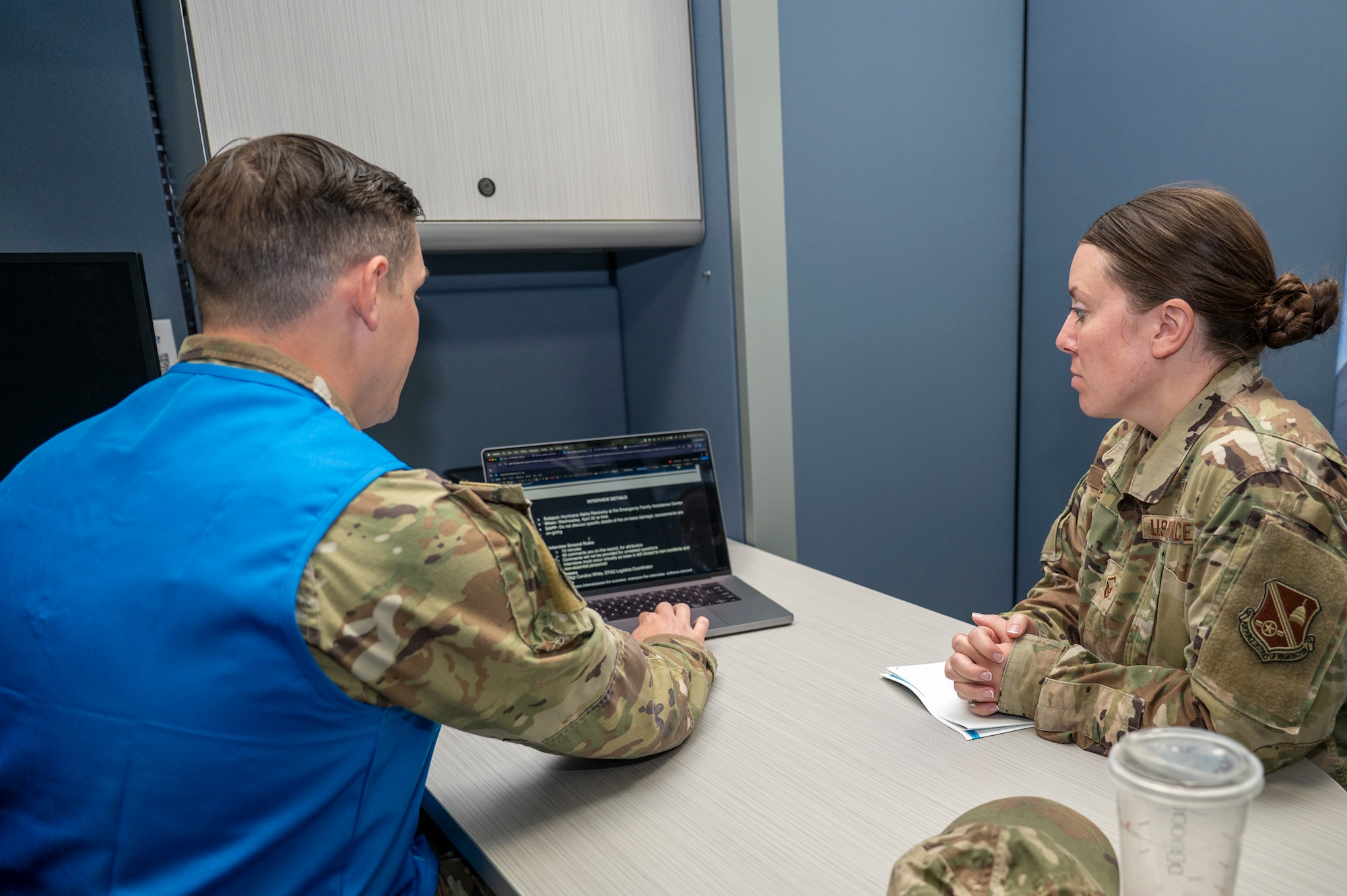U.S. Air Force Staff Sgt. Brandon Schneider, NCOIC of community engagement  assigned to the public affairs, prepares U.S. Air Force Master Sgt., Candace White, 11th Wing Readiness noncommissioned officer in charge, for a media interview during a hurricane training event for the emergency family assistance center (EFAC) at Joint Base Anacostia-Bolling, Washington, D.C., on April 14, 2026. The training prepared JBAB personnel for emergency response for disasters to ensure the members’ safety on the installation. (U.S. Air Force photo by Senior Airman Shanel Toussaint)