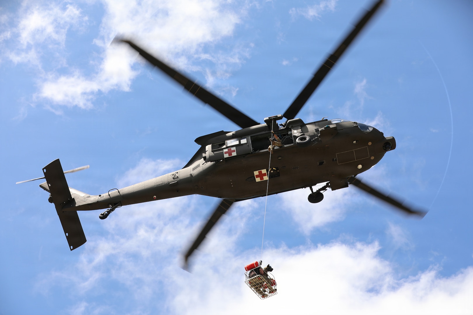 Soldiers from the 36th Combat Aviation Brigade, Texas Army National Guard, conduct a basket lift with a role player and canine during the 2026 Search and Rescue Exercise in the San Antonio area May 18-21.
