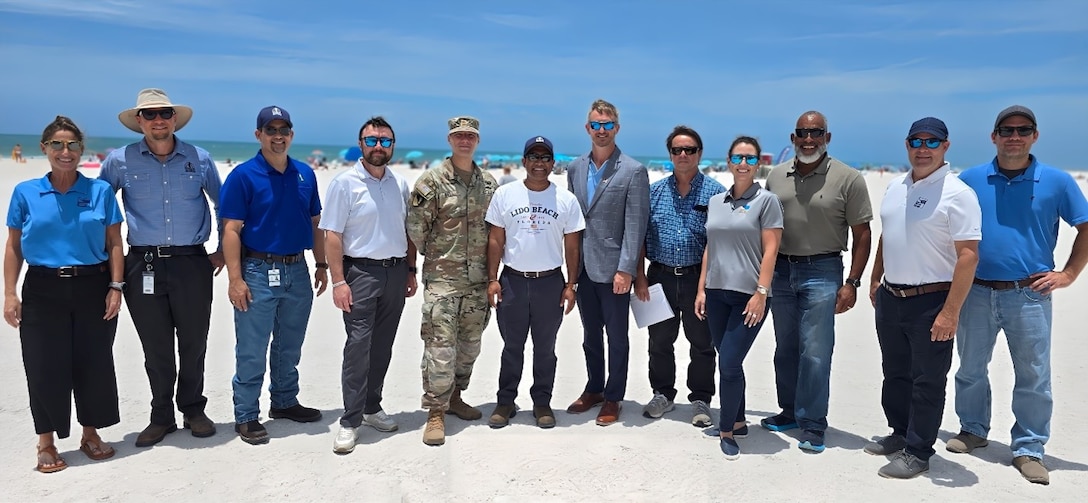 USACE Jacksonville District leadership and project delivery team members cut the ribbon signifying the completion of the Lido Key Beach renourishment project, with Federal and local elected officials and stakeholders.