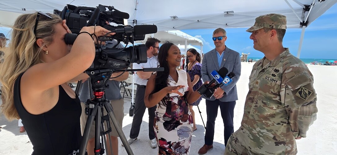 USACE Jacksonville District Deputy Commander for South Florida, Maj. Cory Bell provides interviews to local media about the completion of the Lido Key Beach renourishment effort, using beneficially dredged material from New Pass.