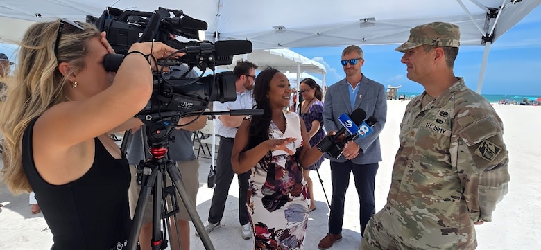 USACE Jacksonville District Deputy Commander for South Florida, Maj. Cory Bell provides interviews to local media about the completion of the Lido Key Beach renourishment effort, using beneficially dredged material from New Pass.