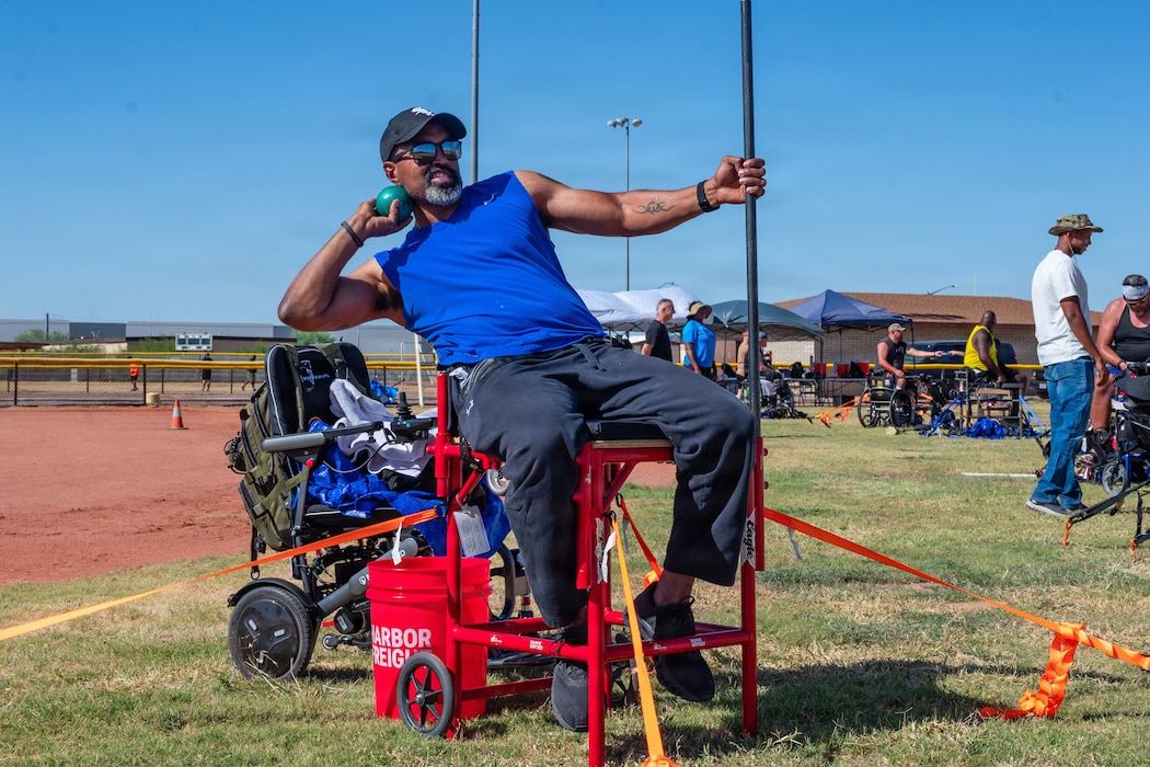 Christopher Francis, a U.S. Marine Corps veteran, throws a shot put during Paralympic training, at Luke Air Force Base, Arizona, May 27, 2026. The Paralympics training event promoted recovery and empowerment through adaptive competition, supporting the physical and mental wellness initiatives that contribute to Luke AFB’s culture of resilience and support for the community. (U.S. Air Force photo by Airman 1st Class Tekorey Watkins)