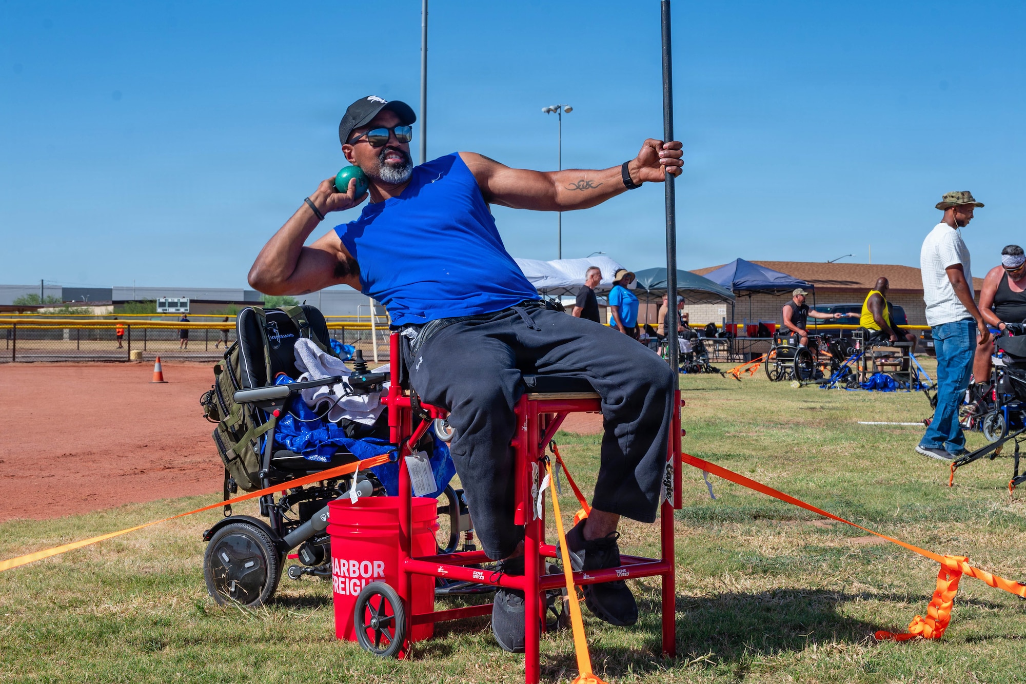 Christopher Francis, a U.S. Marine Corps veteran, throws a shot put during Paralympic training, at Luke Air Force Base, Arizona, May 27, 2026. The Paralympics training event promoted recovery and empowerment through adaptive competition, supporting the physical and mental wellness initiatives that contribute to Luke AFB’s culture of resilience and support for the community. (U.S. Air Force photo by Airman 1st Class Tekorey Watkins)