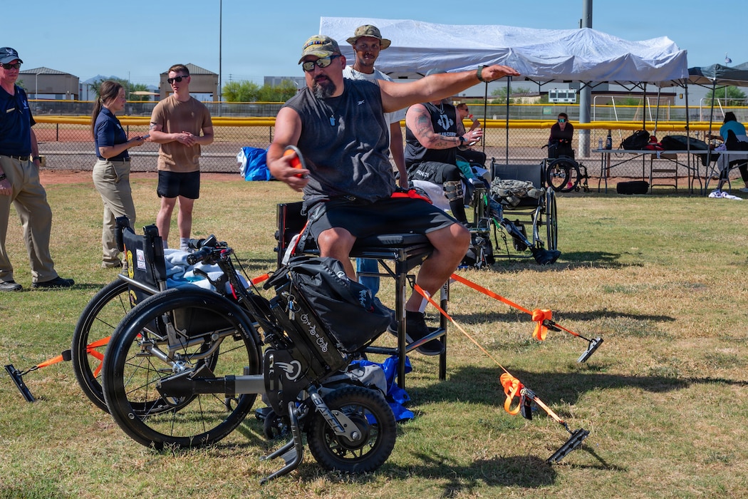 Calixtro Garcia, a U.S. Army veteran, throws a discus during Paralympic training at Luke Air Force Base, Arizona, May 27, 2026. The Paralympics bring together wounded and injured athletes through adaptive competition and recovery-focused programs designed to strengthen camaraderie, mirroring Luke AFB’s culture of resilience in support of combat-ready Airmen. (U.S. Air Force photo by Airman 1st Class Tekorey Watkins)