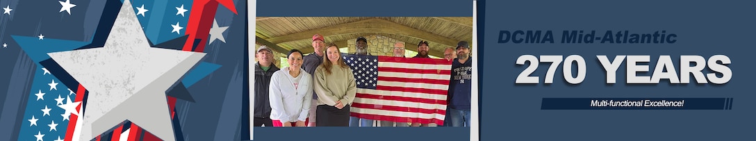 A group poses for a photo outdoors under covered picnic area.