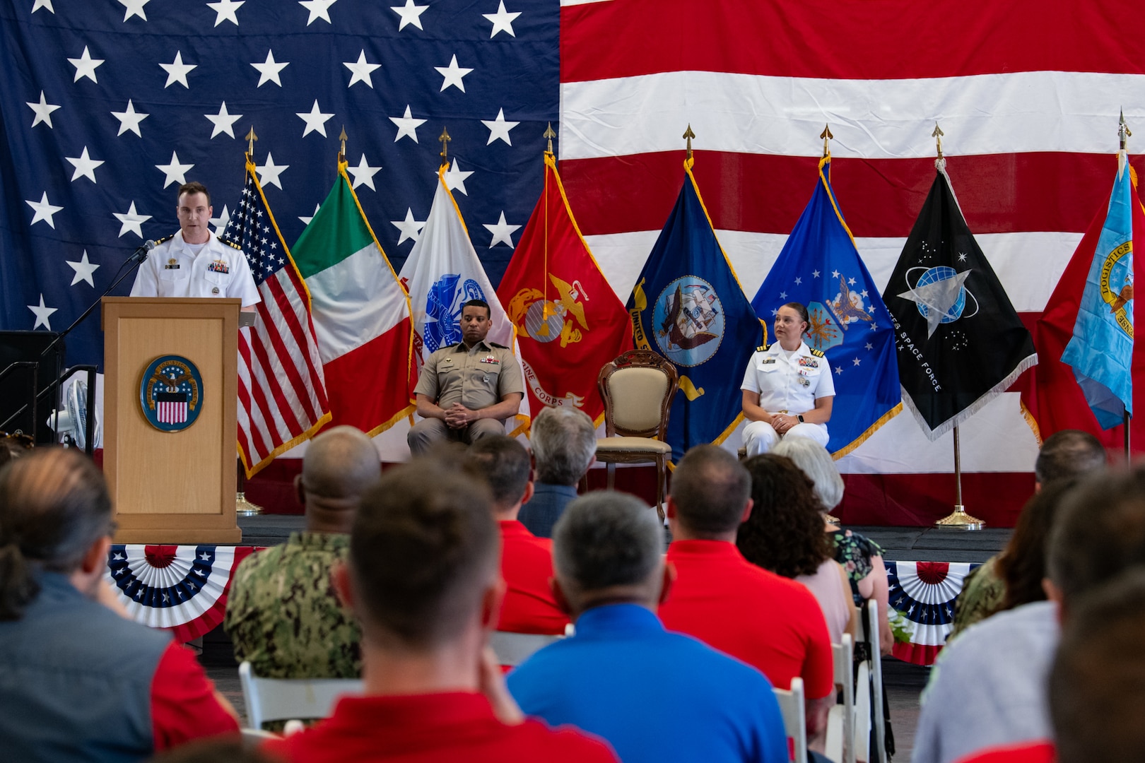 Military officers on a stage.