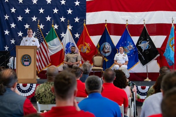 Military officers on a stage.