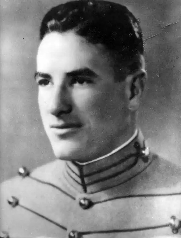 A man is pictured wearing a military dress uniform.