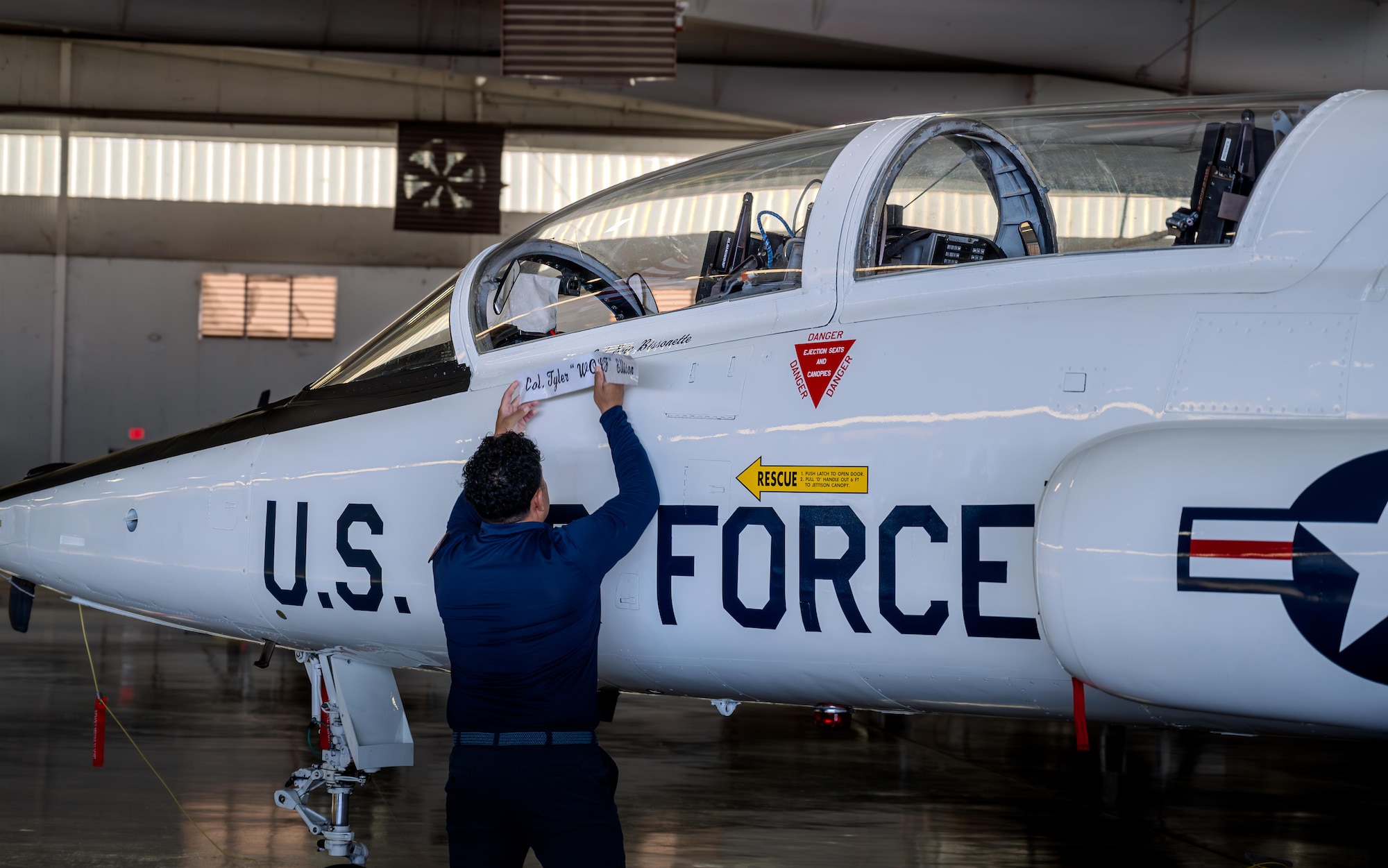U.S. Air Force Eduardo Hernandez, 47th Maintenance Directorate dedicated crew chief, reveals Col. Eric Bissonette’s name on the 47th Flying Training Wing (FTW) flagship during the 47th FTW change of command ceremony at Laughlin Air Force Base, Texas, May 28, 2026. Bissonette accepted the role as the 47th FTW commander from former commander Col. Tyler Ellison. (U.S. Air Force photo by Master Sgt. Laura Claypool)