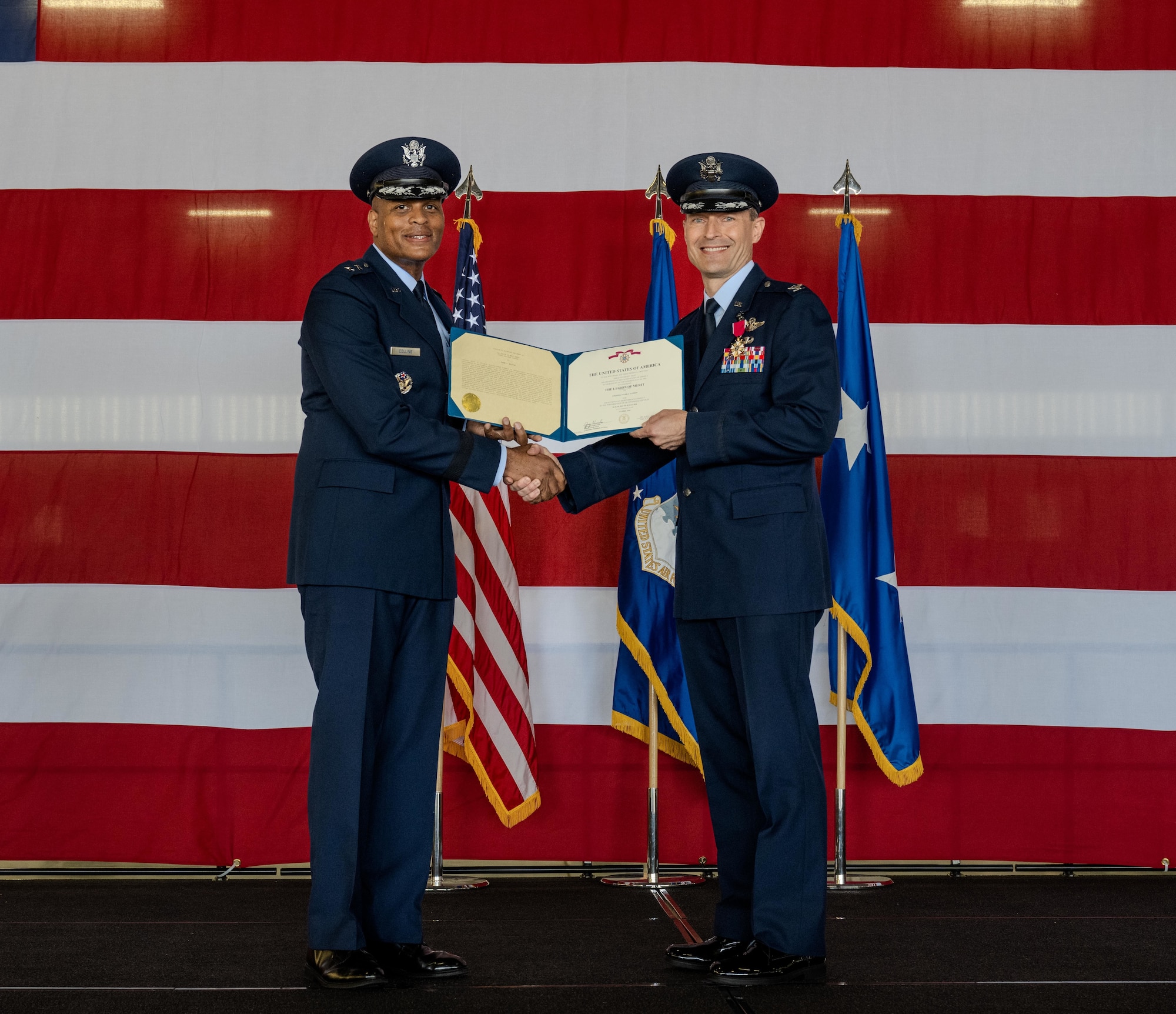 U.S. Air Force Maj. Gen. Roy Collins (left), Air Education and Training Command, deputy commander, presents the Legion of Merit to Col. Tyler Ellison (right), former 47th Flying Training Wing (FTW) commander, during the 47th FTW change of command ceremony at Laughlin Air Force Base, Texas, May 28, 2026. As commander, Ellison oversaw the execution of more than 71,000 aircraft sorties and graduating over 700 student pilots from Undergraduate Pilot Training. (U.S. Air Force photo by Airman 1st Class Harrison Sullivan)