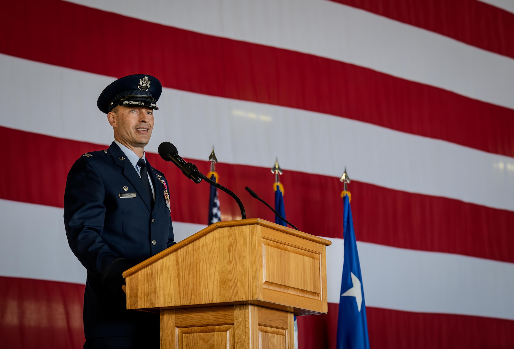 U.S. Air Force Col. Tyler Ellison, 47th Flying Training Wing (FTW) former commander, delivers a speech during the 47th FTW change of command ceremony at Laughlin Air Force Base, Texas, May 28, 2026. Ellison oversaw the execution of over 71,000 sorties, successfully producing more than 700 combat ready pilots. (U.S. Air Force photo by Airman 1st Class Harrison Sullivan)