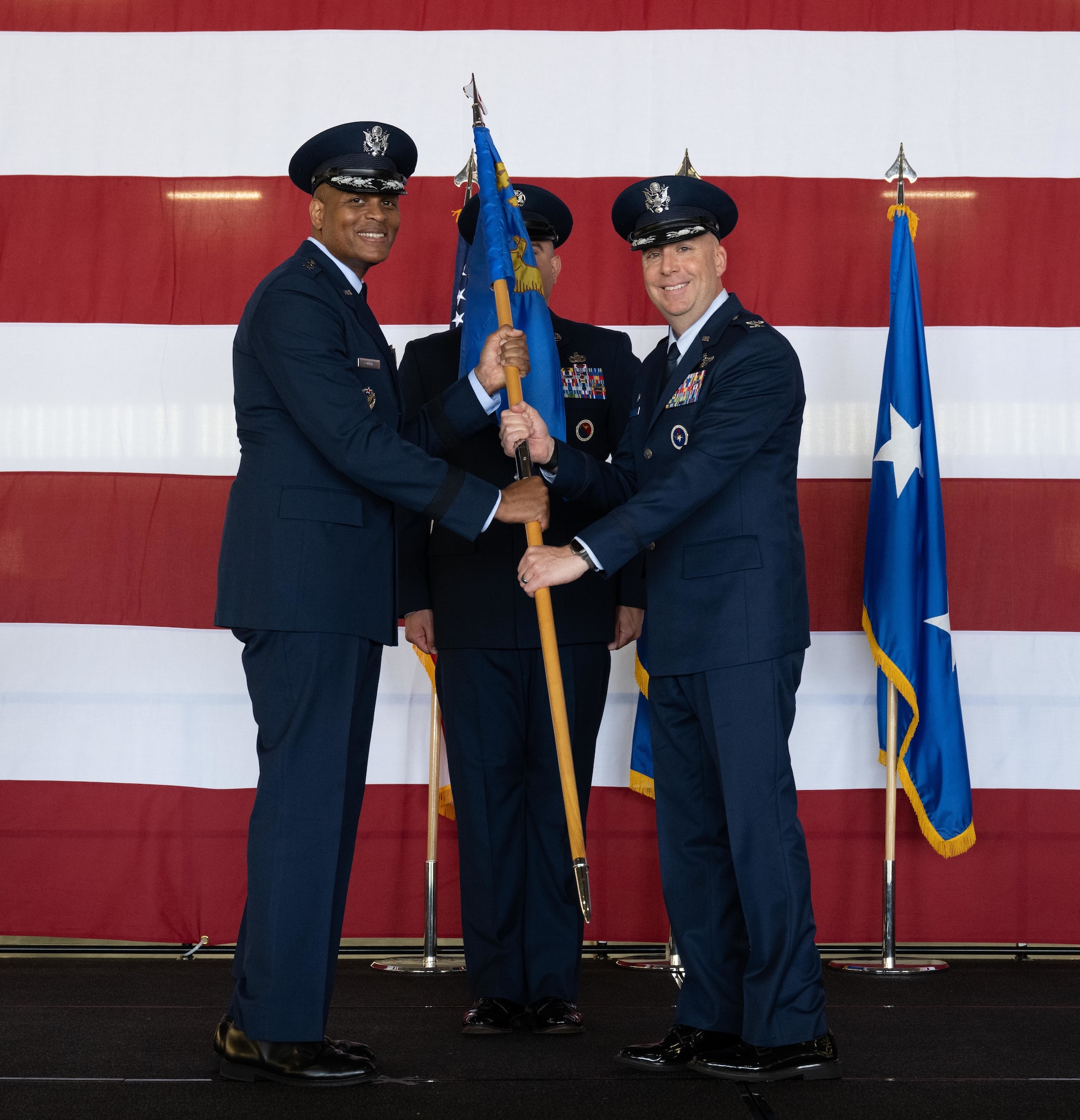 U.S. Air Force Col. Eric Bissonette (left), 47th Flying Training Wing (FTW) commander, accepts the 47th FTW guidon from Maj. Gen. Roy Collins (right), Air Education and Training Command, deputy commander, during the 47th FTW change of command ceremony at Laughlin Air Force Base, Texas, May 28, 2026. As commander, Bissonette will oversee nearly 2,400 military and civilian personnel engaged in executing more than 38,000 aircraft sororities yearly in support of Laughlin’s Undergraduate Pilot Training mission. (U.S. Air Force photo by Airman 1st Class Harrison Sullivan)