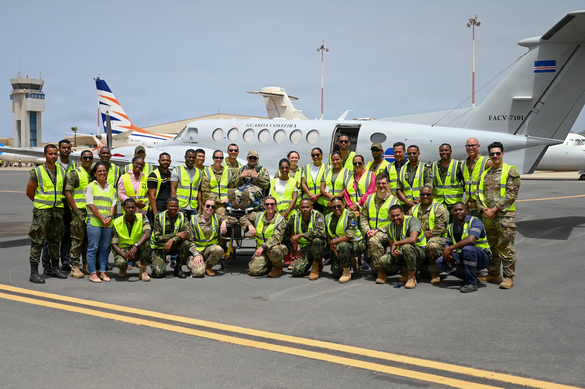 Military personnel in front of a military aircraft
