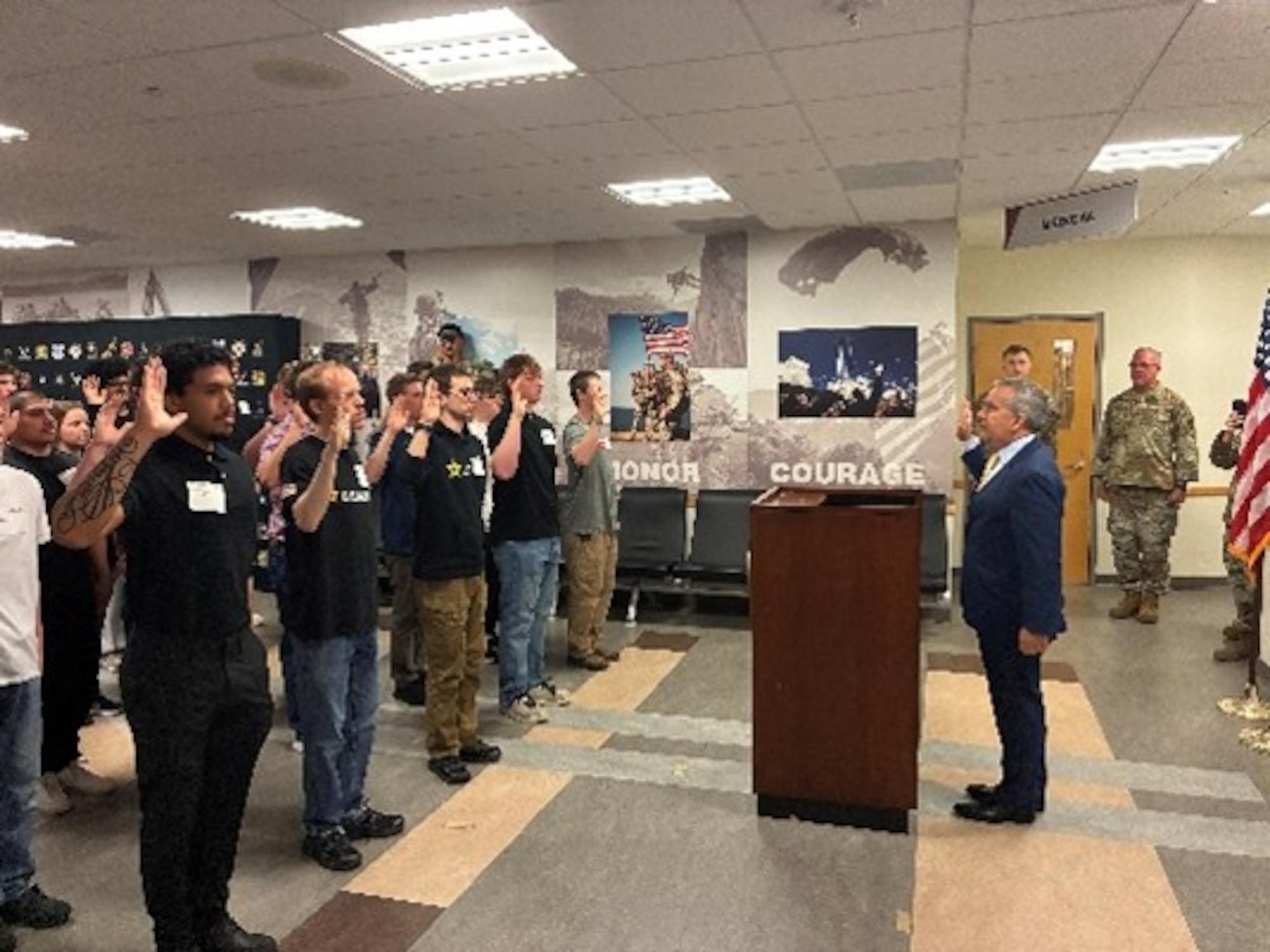 Peter I. Belk, principal deputy assistant secretary of war for readiness, administers the oath of enlistment at Fort Snelling Military Entrance Processing Station, Minneapolis, Minn., on May 26, 2026