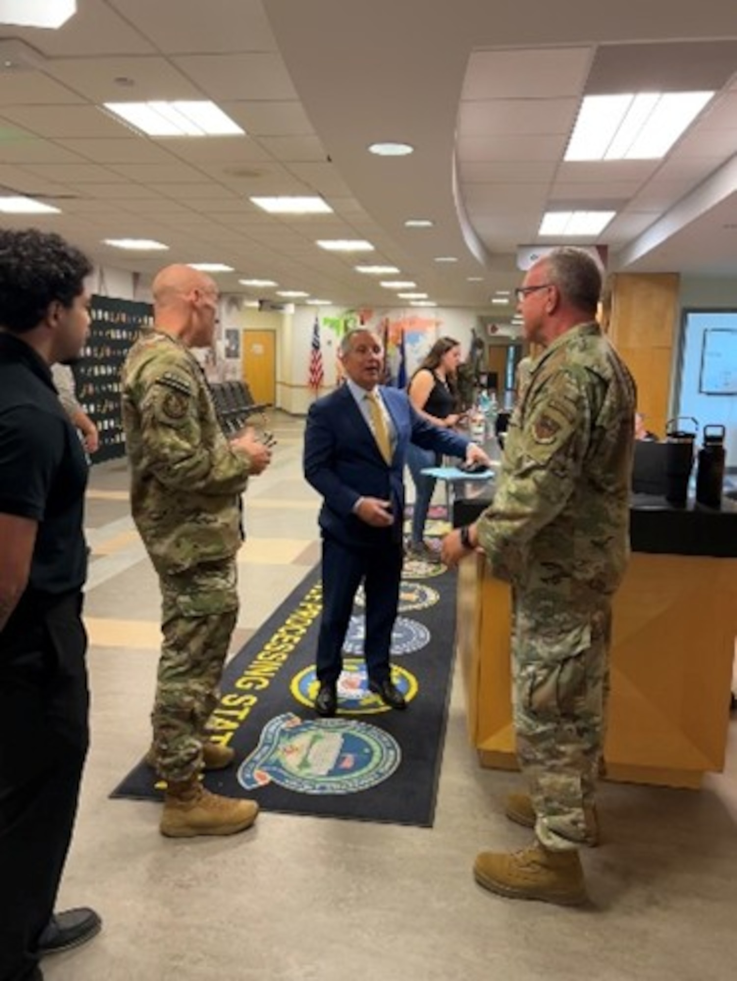 Peter I. Belk, principal deputy assistant secretary of war for readiness, talks with Master Sgt. Thomas Casey, 343d Recruiting Squadron Military Entrance Processing Station liaison, at Fort Snelling Military Entrance Processing Station, Minneapolis, Minn., on May 26, 2026.