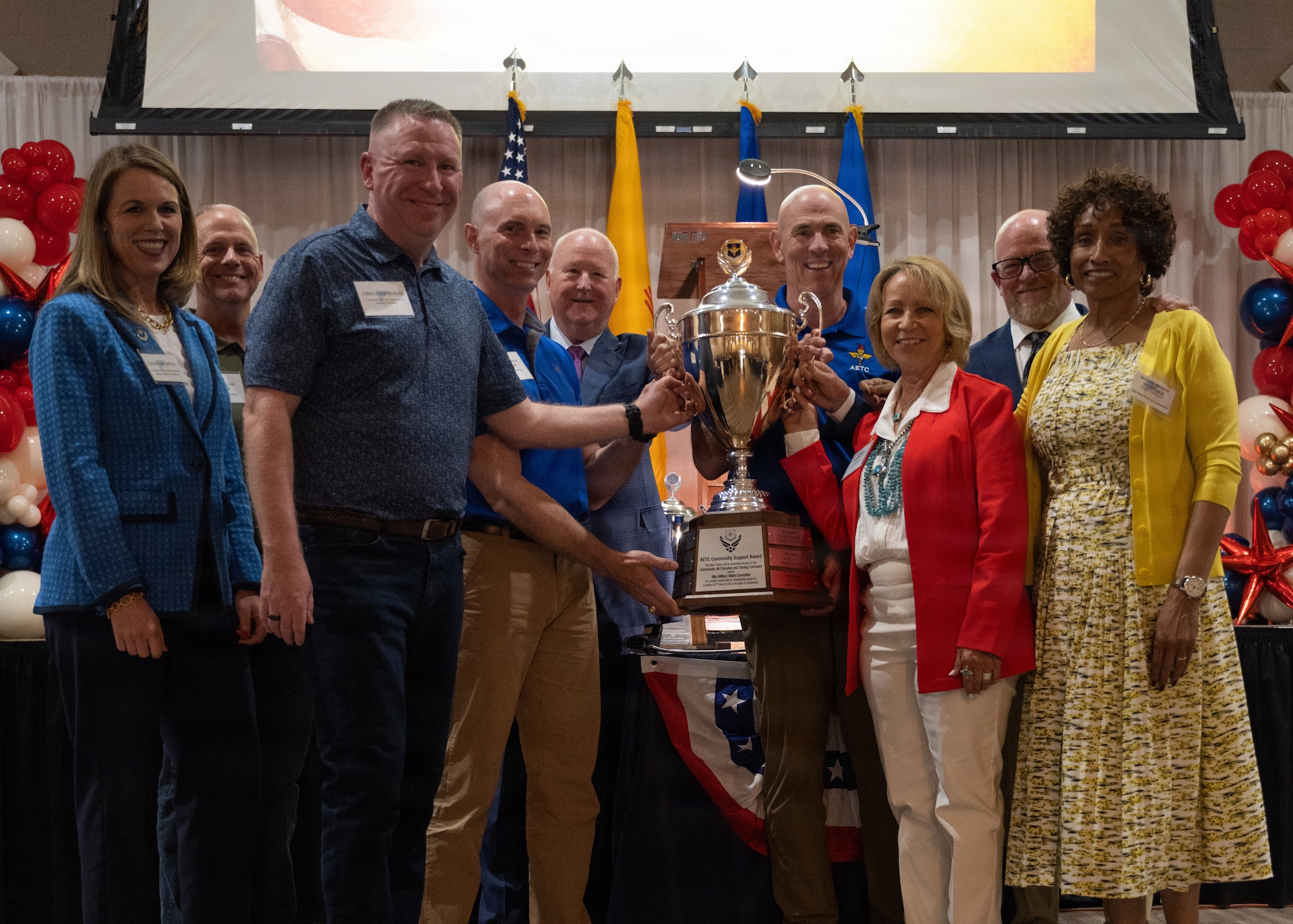 Leaders from Air Education and Training Command, Holloman Air Force Base, and Alamogordo civic leaders pose with the Altus Military Affairs Community Support Award (Altus Trophy)