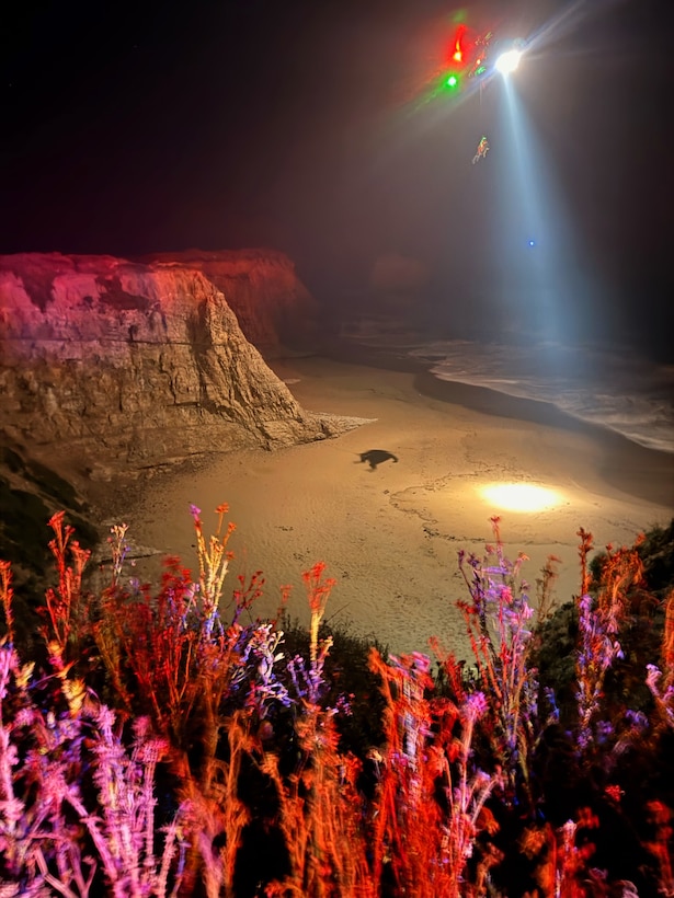 A U.S. Coast Guard Air Station San Francisco MH-65 Dolphin aircrew rescues three people from a cave near Santa Cruz, California, May 17, 2026.  Air crew members hoisted all three individuals and transferred them to the care of nearby CAL FIRE and Santa Cruz County Fire personnel for further evaluation. (U.S. Coast Guard photo by Petty Officer 2nd Class Thomas Sizer)