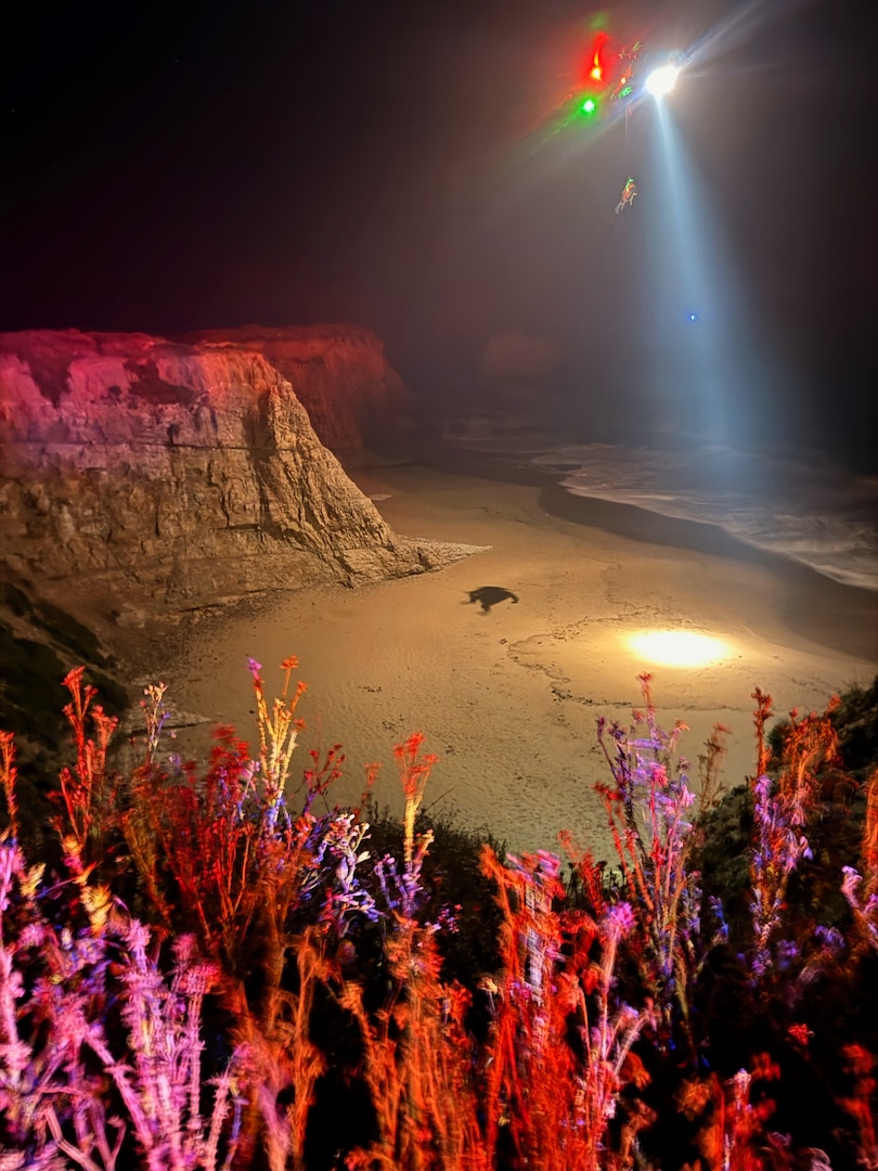 A U.S. Coast Guard Air Station San Francisco MH-65 Dolphin aircrew rescues three people from a cave near Santa Cruz, California, May 17, 2026.  Air crew members hoisted all three individuals and transferred them to the care of nearby CAL FIRE and Santa Cruz County Fire personnel for further evaluation. (U.S. Coast Guard photo by Petty Officer 2nd Class Thomas Sizer)
