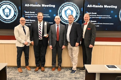 The CIO's Office is proud to announce our Workforce Innovation Directorate’s (WID) has been awarded the 2026 Government Information Technology Council’s Workforce Development Award! This award, presented by the Advanced Technology Academic Research Center (ATARC), honors groundbreaking solutions to federal challenges. It specifically recognizes the Workforce Innovation Directorate’s (WID) pioneering Skills-Based Hiring Pilot. Selected from a highly competitive field, this program reimagines traditional resume-based hiring by utilizing hands-on assessments to evaluate real-world cyber skills.  During a WID All-Hands meeting on May 7th, ATARC Founder Tom Suder and Director of Government Engagement Tim Harvey presented this prestigious award to our recipients:  
Pictured left to right: Alfredo Rodriguez; Matt Isnor; Walt Spears; Tom Suder – Founder of Advanced Technology Academic Research Center and Mark Gorak.