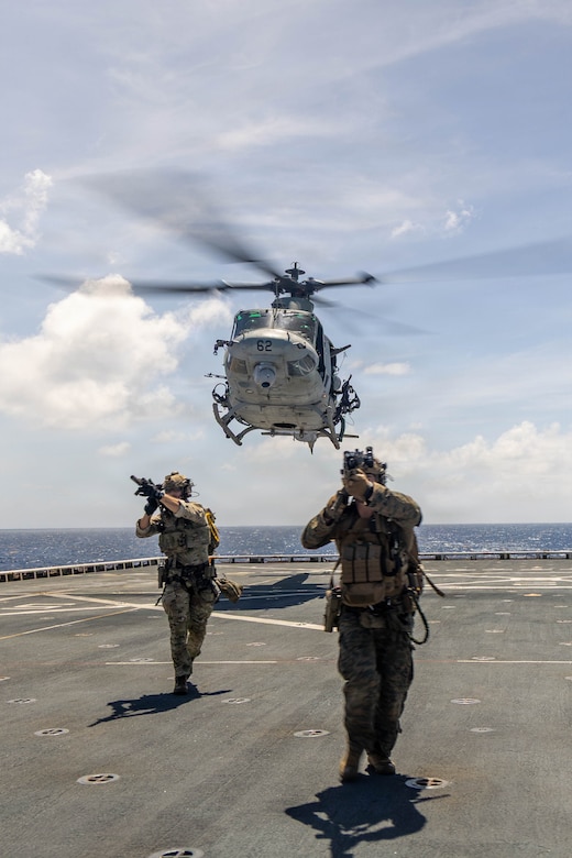 A U.S. Coast Guardsman, left, with Tactical Law Enforcement Team Pacific, and a U.S. Marine with Maritime Raid Force, Littoral Combat Force-24, move to their objective after fast-roping off of a UH-1Y Venom assigned to Marine Medium Tiltrotor Squadron (VMM) 365 (Reinforced), LCF-24, during a Maritime Interdiction Operation Full Mission Profile rehearsal aboard San Antonio-class amphibious transport dock USS Fort Lauderdale (LPD 28) while underway in the Caribbean Sea, May 22, 2026. U.S. military forces are deployed to the U.S. Southern Command area of responsibility in support of Operation SOUTHERN SPEAR, Department of War-directed operations, and the president’s priorities to disrupt illicit drug trafficking, deter malign actors and protect the homeland through continuous presence. (U.S. Marine Corps photo)