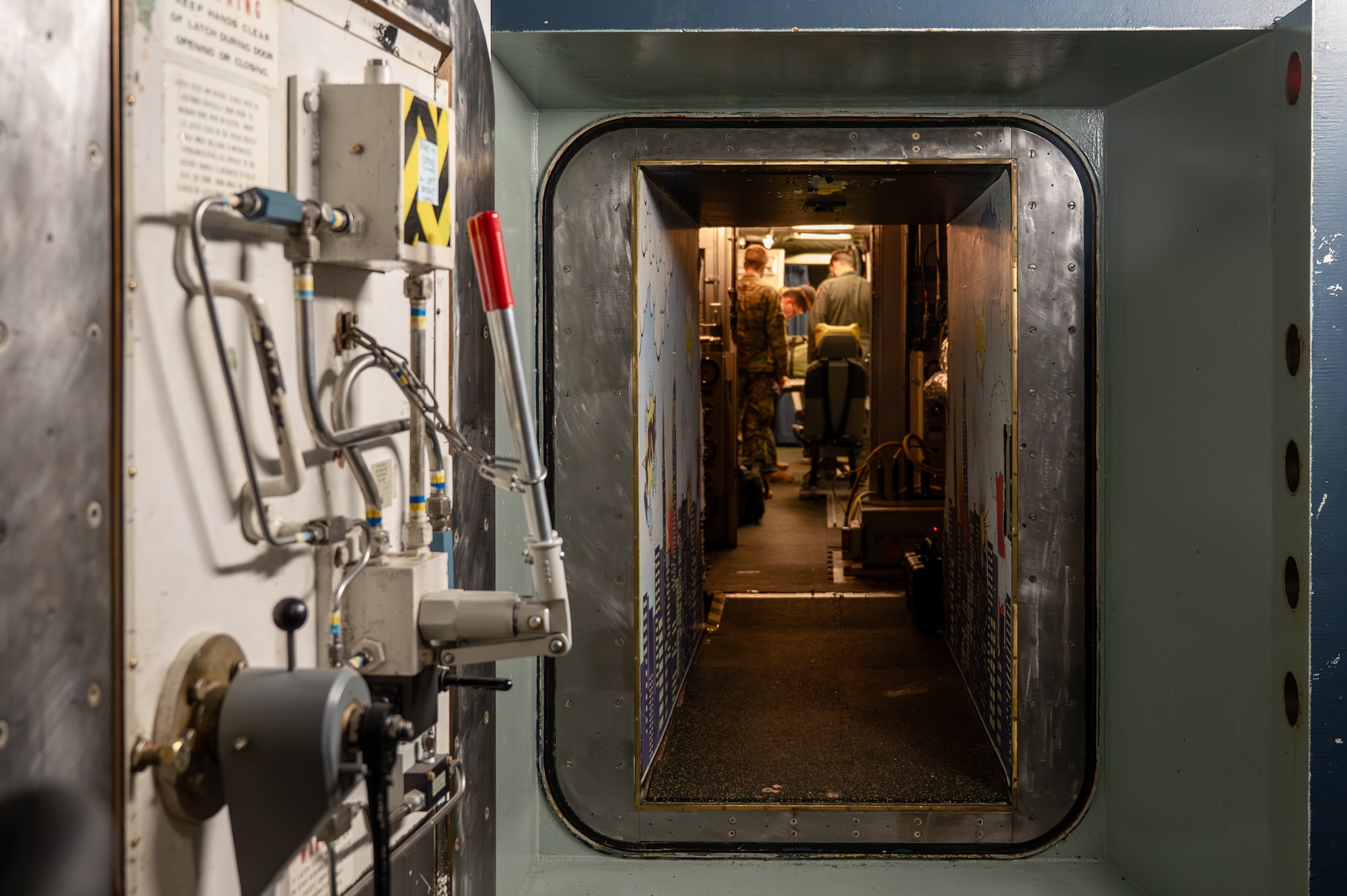 A launch control center frames a group of military personnel.